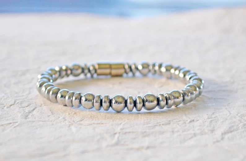 Silver magnetic bracelet handcrafted with silver metallic magnetic hematite beads. It is secured with a strong and easy-to-use magnetic clasp.