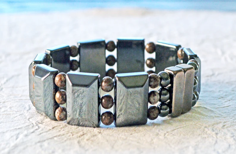Magnetic bracelet handcrafted with black magnetic hematite beads and snowflake jasper gemstone beads. It is secured with a strong and easy-to-use rare earth magnetic clasp.