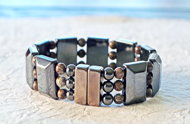 Magnetic bracelet handcrafted with black magnetic hematite beads and snowflake jasper gemstone beads. It is secured with a strong and easy-to-use rare earth magnetic clasp.