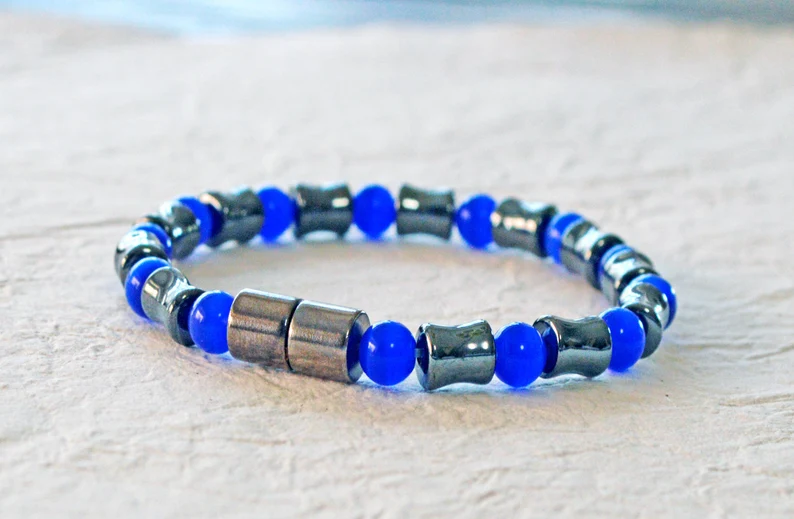 Magnetic bracelet handcrafted with alternating black high power magnetic hematite beads and blue cat's eye beads. It is secured with a strong and easy-to-use magnetic clasp.